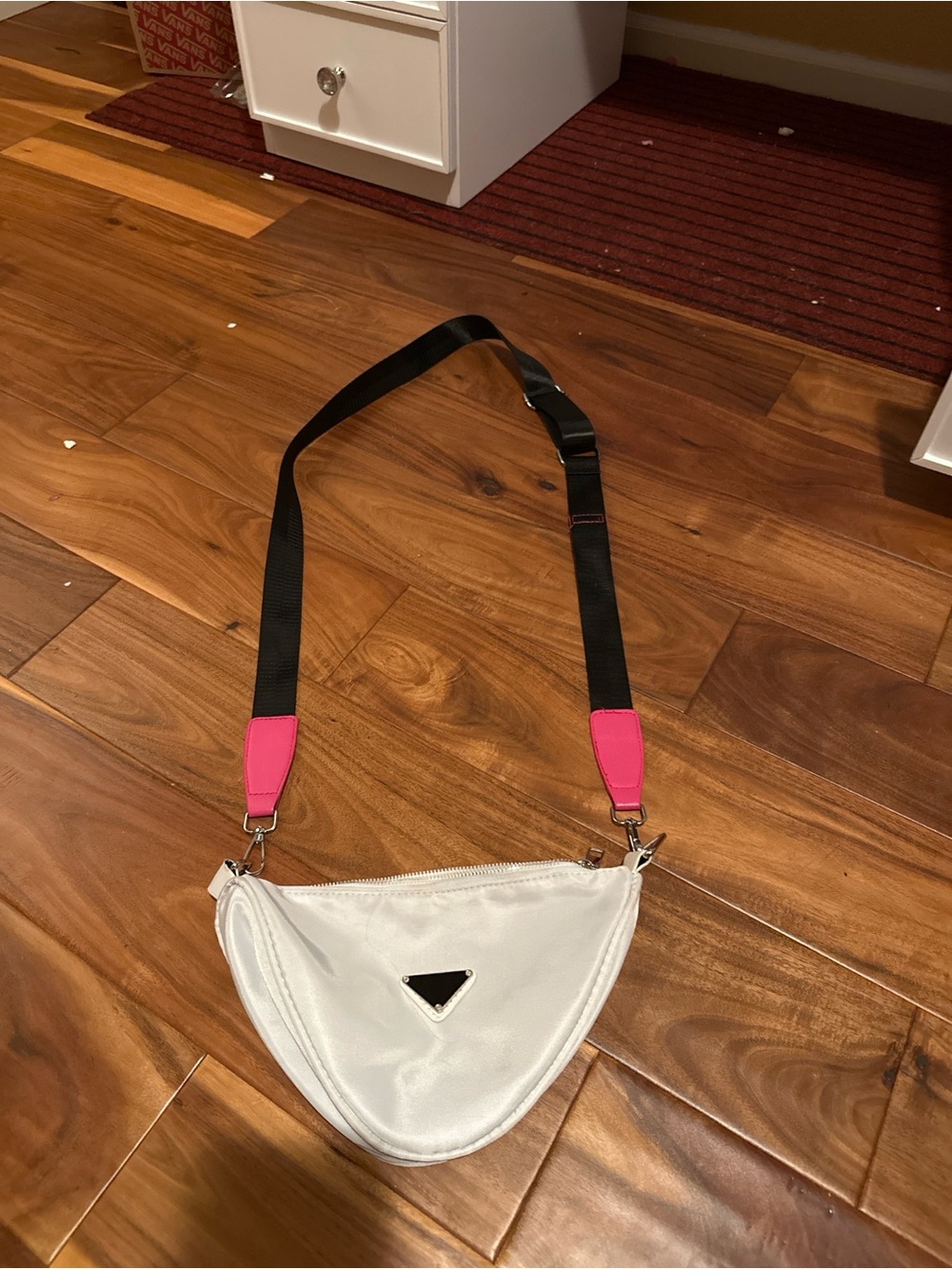 White Triangle Crossbody Bag with Black Strap and Pink Accents